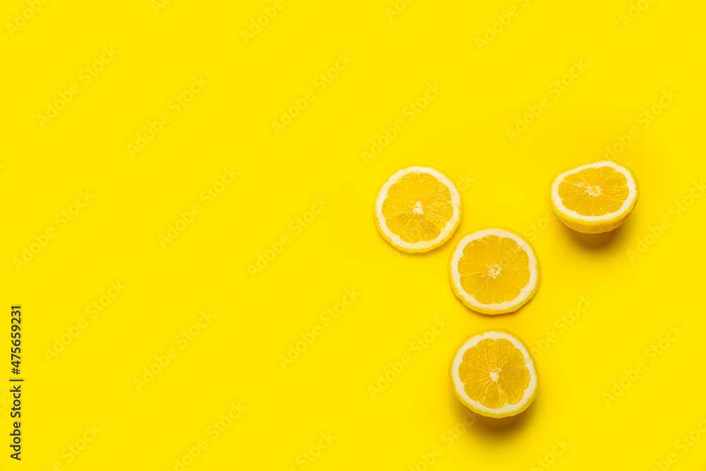 Fototapeta slice of yellow lemon on a yellow background. Top view, flat lay