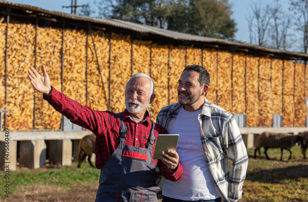 Φωτογραφία Happy ranchers using touchpad on a farm.