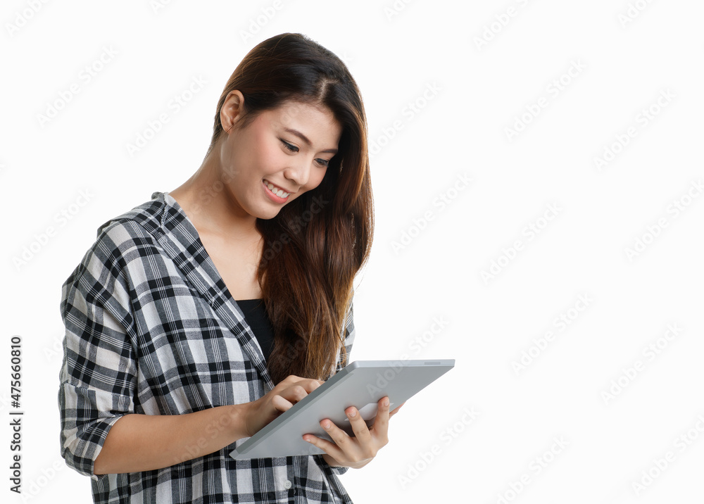Studio shot Asian happy pretty long hair female student model in plaid shirt standing smiling holding touchscreen tablet browsing surfing internet shopping online distant learning on white background Studio shot Asian happy pretty long hair female student model in plaid shirt standing smiling holding touchscreen tablet browsing surfing internet shopping online distant learning on white background