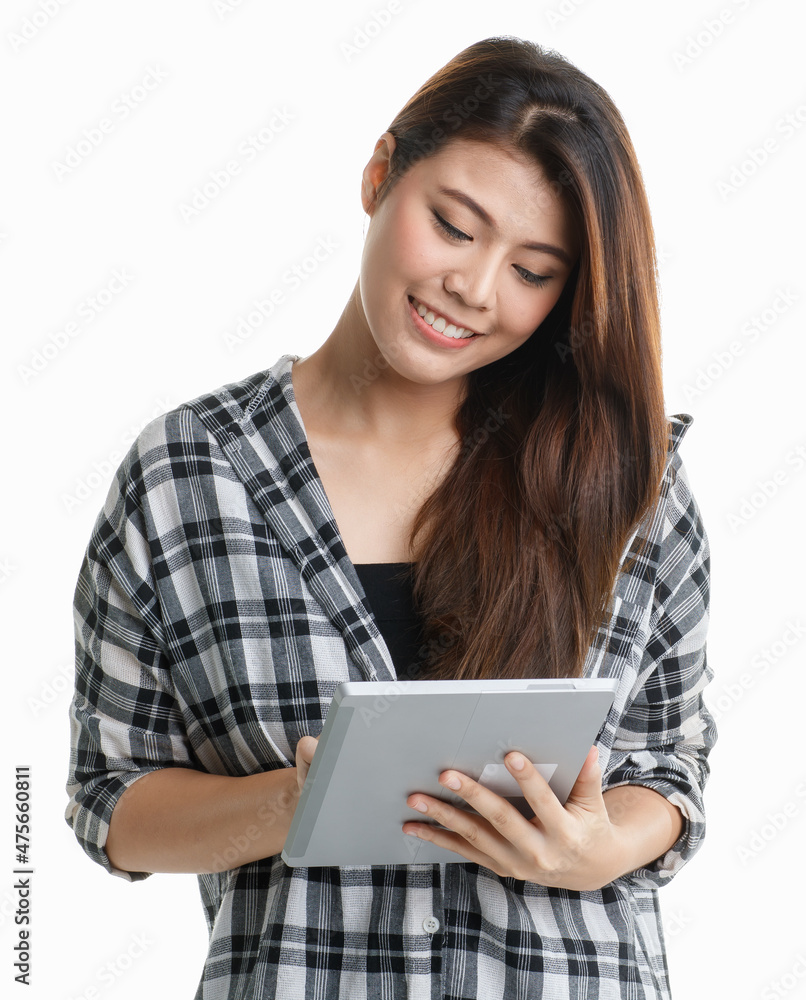 Studio shot Asian happy pretty long hair female student model in plaid shirt standing smiling holding touchscreen tablet browsing surfing internet shopping online distant learning on white background Studio shot Asian happy pretty long hair female student model in plaid shirt standing smiling holding touchscreen tablet browsing surfing internet shopping online distant learning on white background