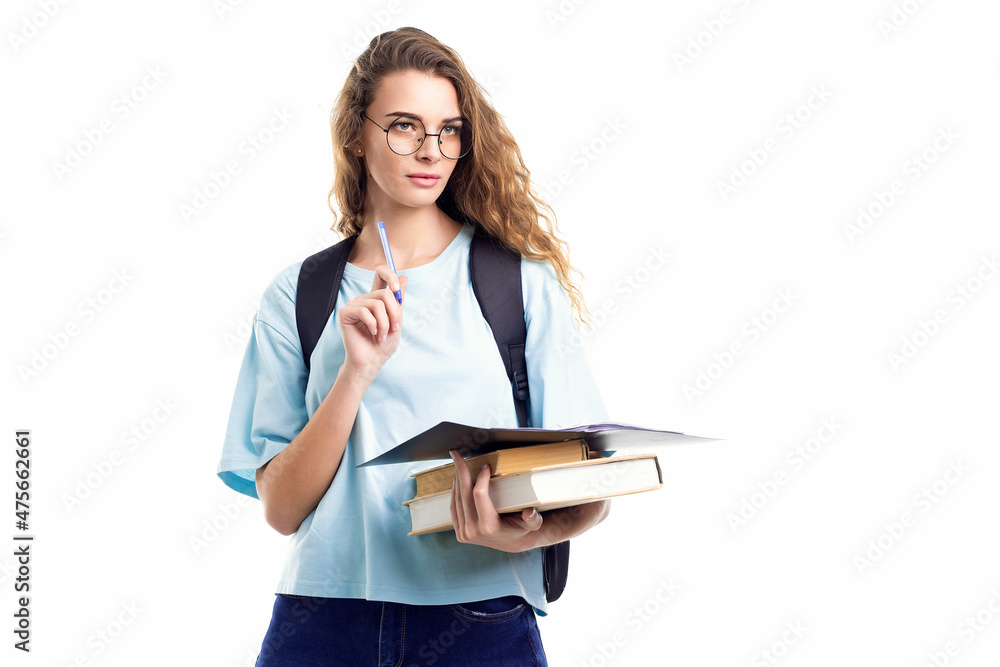 Thoughtful student girl holds pencil and books while looking away. Education concept Thoughtful student girl holds pencil and books while looking away. Education concept