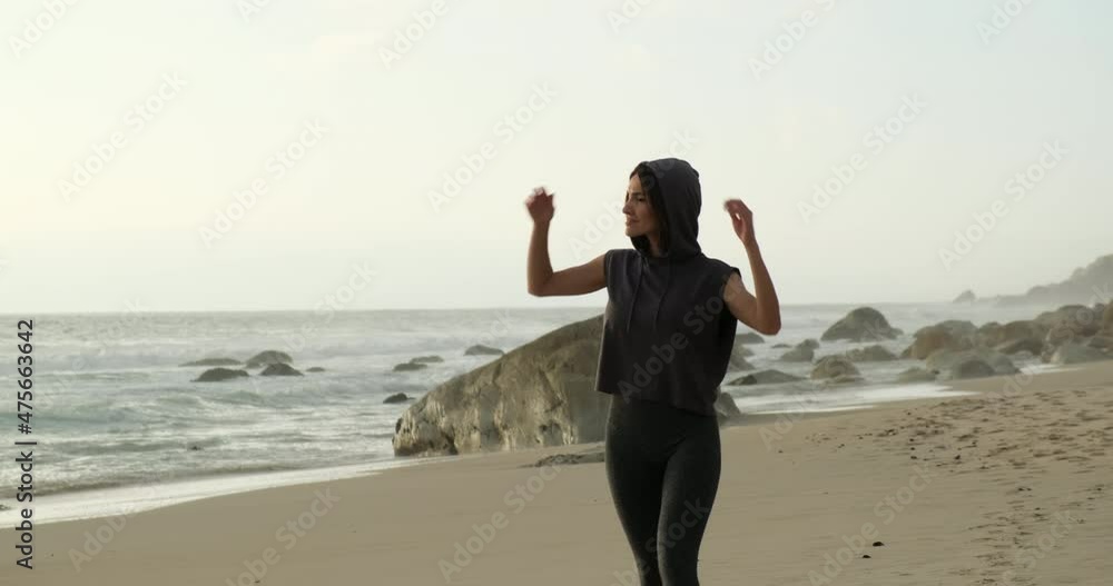 Woman meditating on the beach near Ocean. Alone travel healthy lifestyle. Healthy life Concept. stylish girl in sportswear enjoying the sound of the ocean waves. Body and mind balance. athletic arms Woman meditating on the beach near Ocean. Alone travel healthy lifestyle. Healthy life Concept. stylish girl in sportswear enjoying the sound of the ocean waves. Body and mind balance. athletic arms