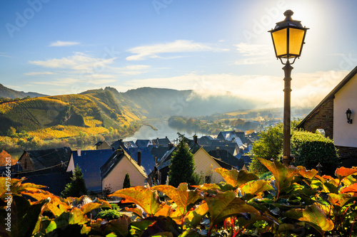 The Moselle loop, a beautiful river in Germany, makes a 180 degree loop. with vineyards and a great landscape and lighting in the morning. the church tower and the town of Bremm in autumn photo