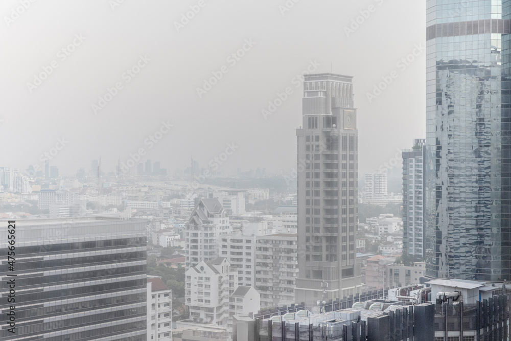 Downtown skyscrapers of the city of Bankok. Poor visibility, smog, caused by dust and smoke high level PM2.5  air pollution.