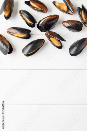 Pattern of mussels are on white wooden background. Flat lay. Copy space.