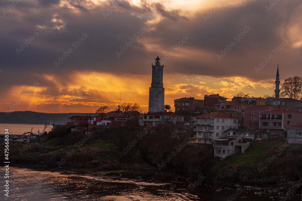 Light house at Rumelifeneri marina in Istanbul. Blue sky and natural white clouds. Sunrise 