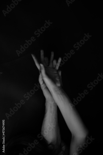 praying hands on black background