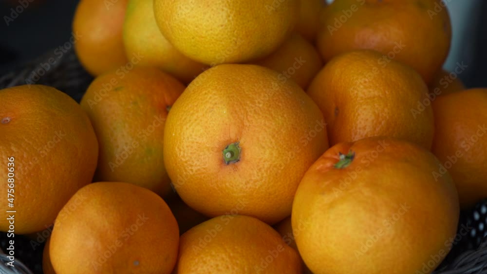 many tangerines lie close-up with an approaching camera many tangerines lie close-up with an approaching camera