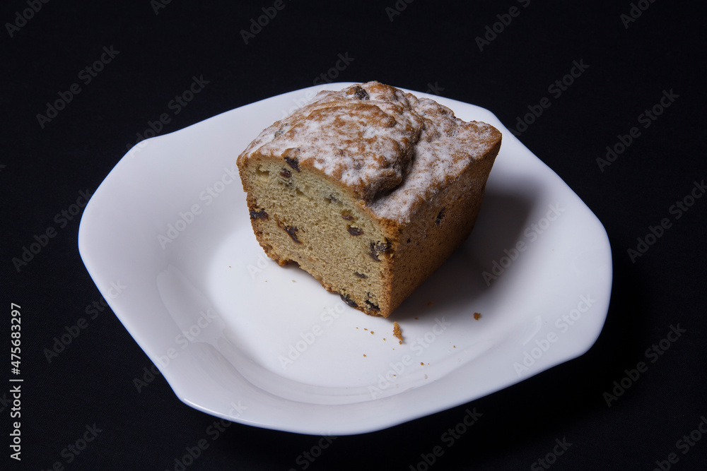 Cupcake with raisins on a white plate Cupcake with raisins on a white plate