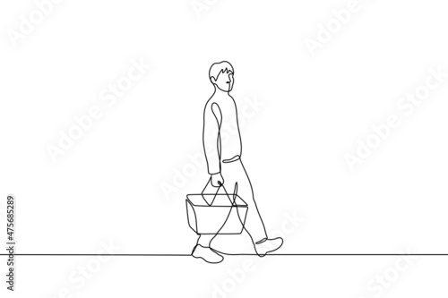 male shopper walks holding a shopping basket - one line drawing vector. shopping concept
