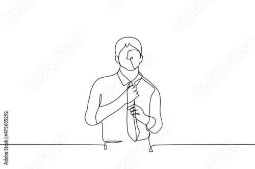 man stands in shirt and straightens tie - one line drawing vector. concept of buying clothes tie, office work