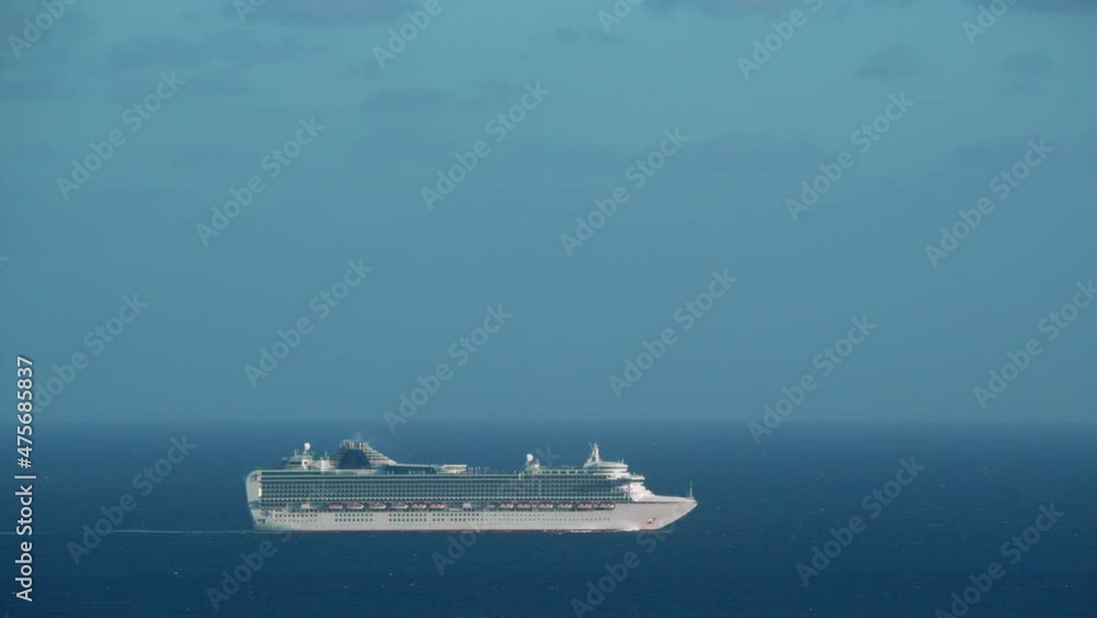 Long shot - The cruise liner is picking up speed, going off into the distance on the water surface Long shot - The cruise liner is picking up speed, going off into the distance on the water surface