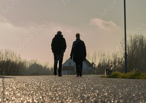 pareja con perro paseando photo