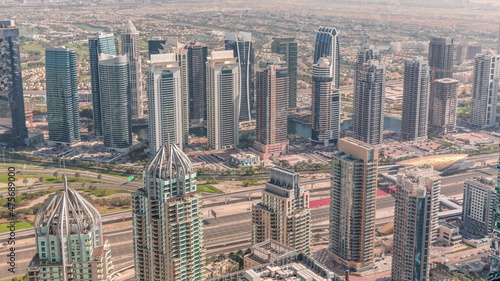 Dubai marina towers with traffic on Sheikh Zayed road near metro station timelapse.