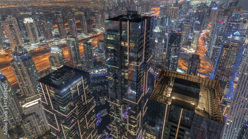Dubai Marina and JLT district with traffic on highway between skyscrapers aerial night timelapse. © neiezhmakov