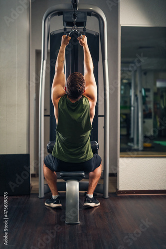 lat pull at multi lat machine wit v-form handle at gym