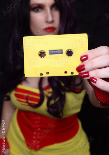 Konstfotografi Yellow Cassette Tape With Woman in Retro clothing in background