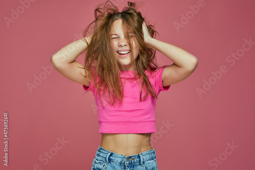 Energetic naughty hooligan little child girl ruffle long blond hair, having fun. Child's hairs care. Positive emotions © Georgii