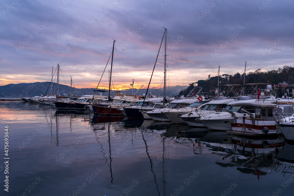 view of sailboats and yachts moored in the marina of  Istanbul, Turkey. Sunrise with colorful clouds and sky