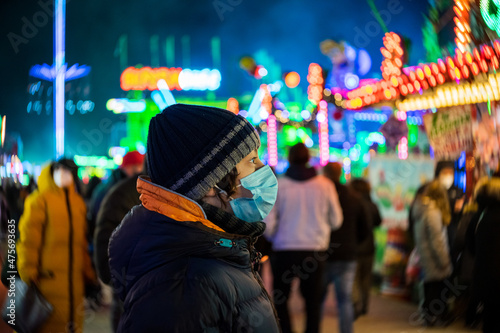 A teenager at a Christmas market during COVID-19 pandemic restrictions. © Sergey Kohl