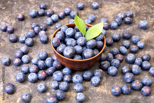 Organic fresh blueberries in a wooden bowl