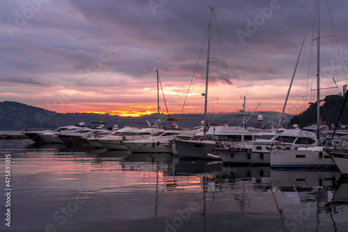 view of sailboats and yachts moored in the marina of Istanbul, Turkey. Sunrise with colorful clouds and sky