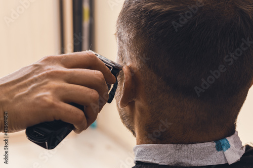 Man's head and hair clipper, hairdressing at home.