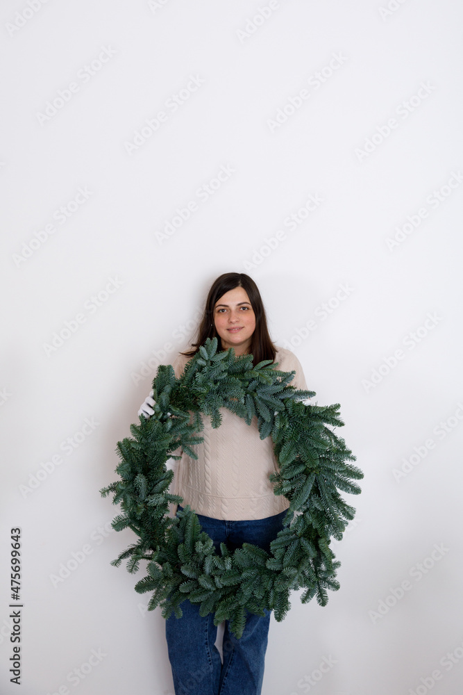 DIY Christmas composition from nobilis. Wreath decor for holiday decorations. Girls at a workshop on making floristry from tree branches DIY Christmas composition from nobilis. Wreath decor for holiday decorations. Girls at a workshop on making floristry from tree branches