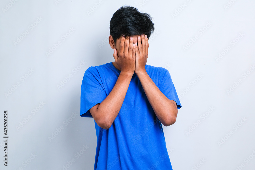 Asian man with sad expression covering face with hands while crying. depression concept Asian man with sad expression covering face with hands while crying. depression concept
