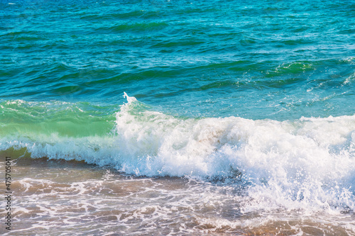 Soft wave of blue sea on sandy beach.