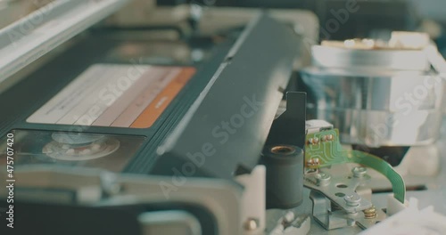 Inserting a retro VHS tape into the videorecorder. photo