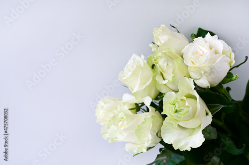 Bouquet of white roses on a white background with soft focus. Spring flower background. Copy space © IULIIA GUSEVA