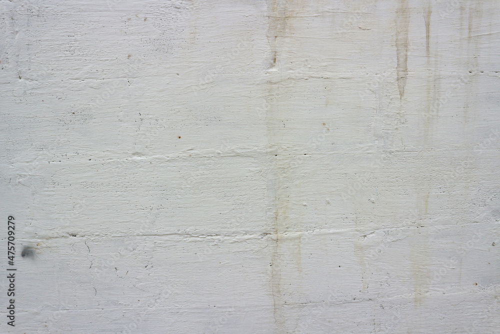 Obraz premium Old wall painted with white paint with the texture of a large brick. 