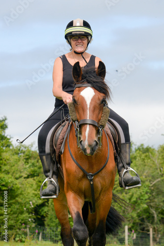Woman riding a horse in the summer
