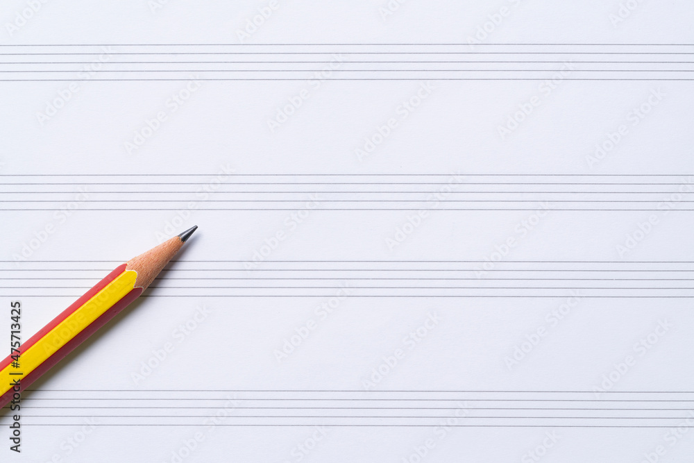 A pencil on the music sheet , musical concept A pencil on the music sheet , musical concept