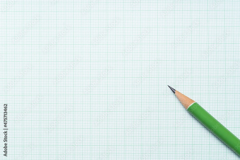 close up green pencil on graph paper background, education concept close up green pencil on graph paper background, education concept
