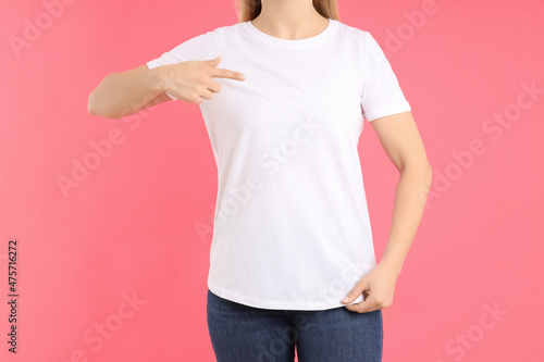 Woman in blank white t-shirt on pink background