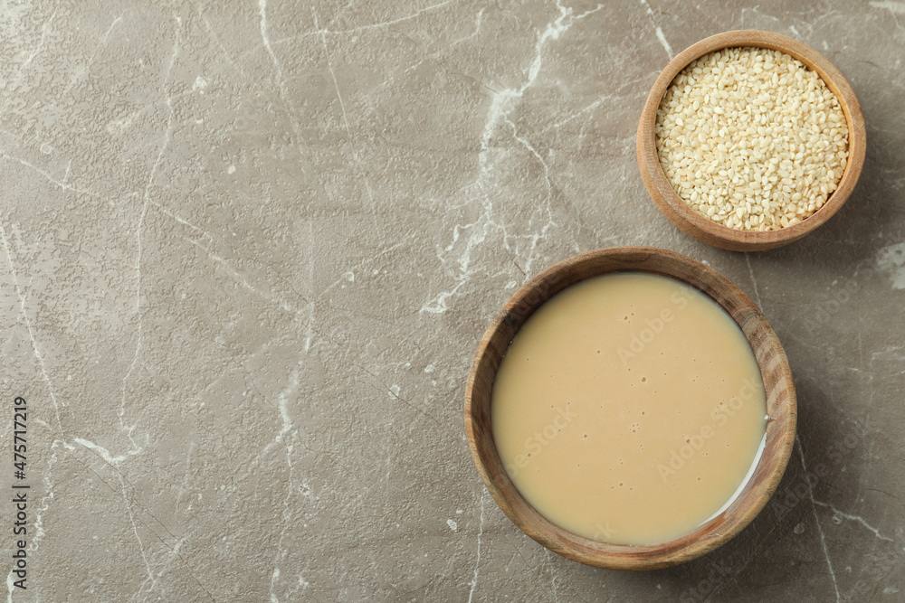 Concept of tasty food with tahini sauce on beige textured background Concept of tasty food with tahini sauce on beige textured background