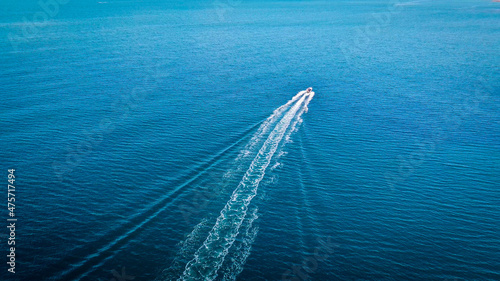 Aerial view of a boat alone in the blue sea