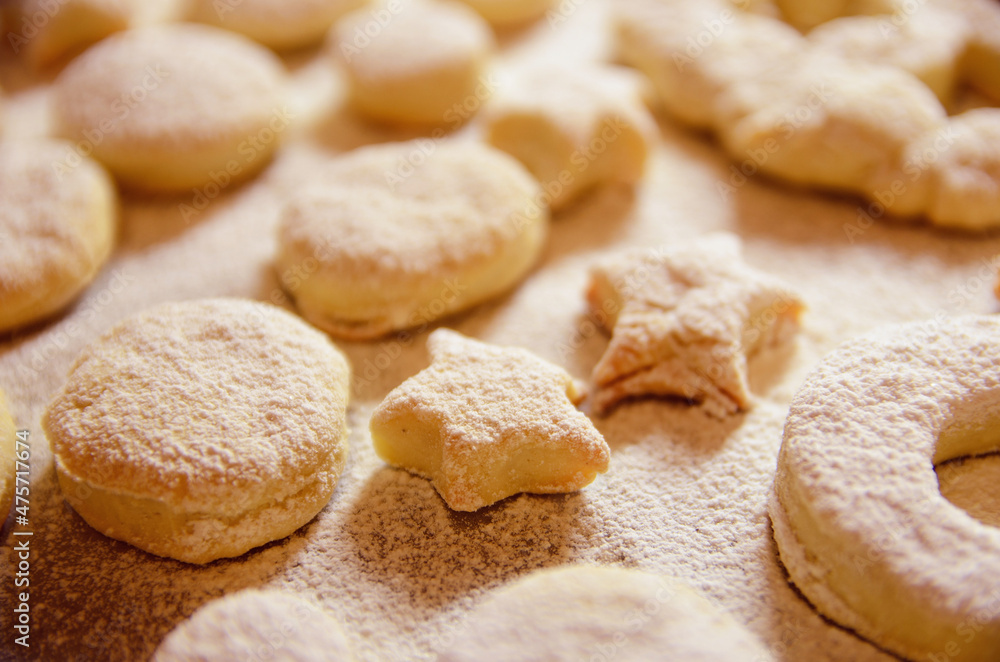 Homemade Creamy oil cookies on a baking sheet sprinkled sugar powder Homemade Creamy oil cookies on a baking sheet sprinkled sugar powder