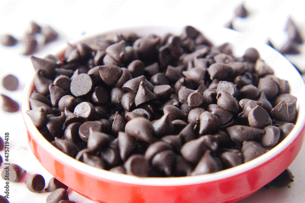Chocolate chips spilling from a plastic packet, Chocolate chips spilling from a plastic packet,