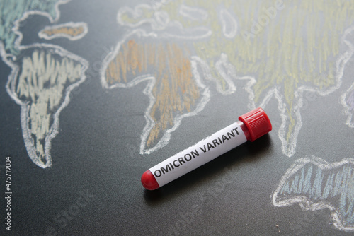 omicron variant corona virus blood test tube and world map 