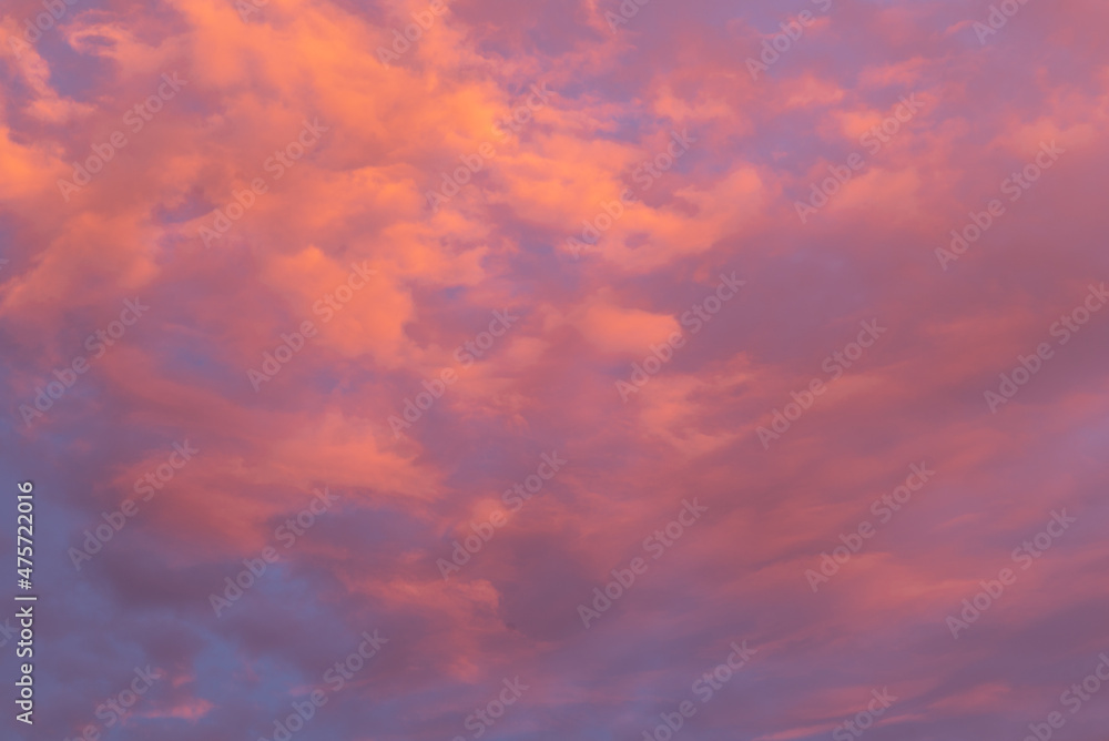Purple, orange and pink clouds at sunset sky.
