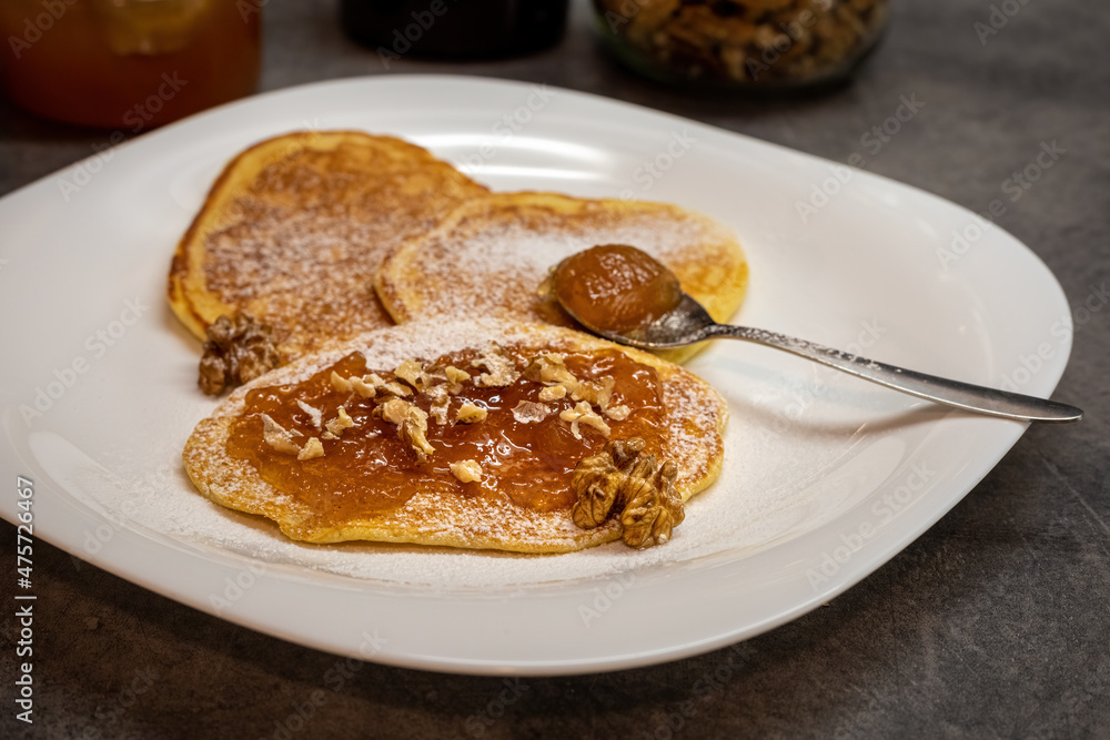 Pancakes with jam and walnuts on plate Pancakes with jam and walnuts on plate
