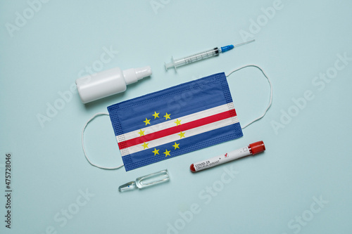 Blood tube for test detection of virus Covid-19 Omicron Variant with positive result, medicine mask with Cape Verde flag superimposed and vaccine.  New Variant of the Covid-19 Omicron photo
