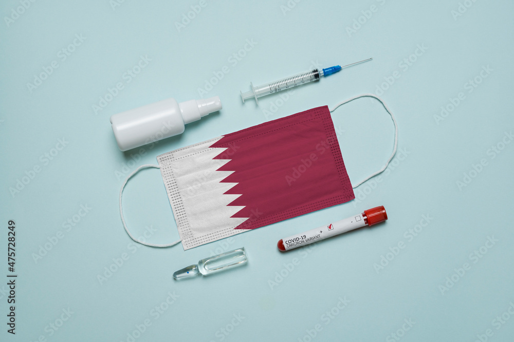 Blood tube for test detection of virus Covid-19 Omicron Variant with positive result, medicine mask with Qatar flag superimposed and vaccine.  New Variant of the Covid-19 Omicron
