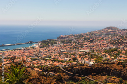 View of the local Madeiran villages, sea and landscape from the perspective of a cable car, Madeira island, Portugal. photo
