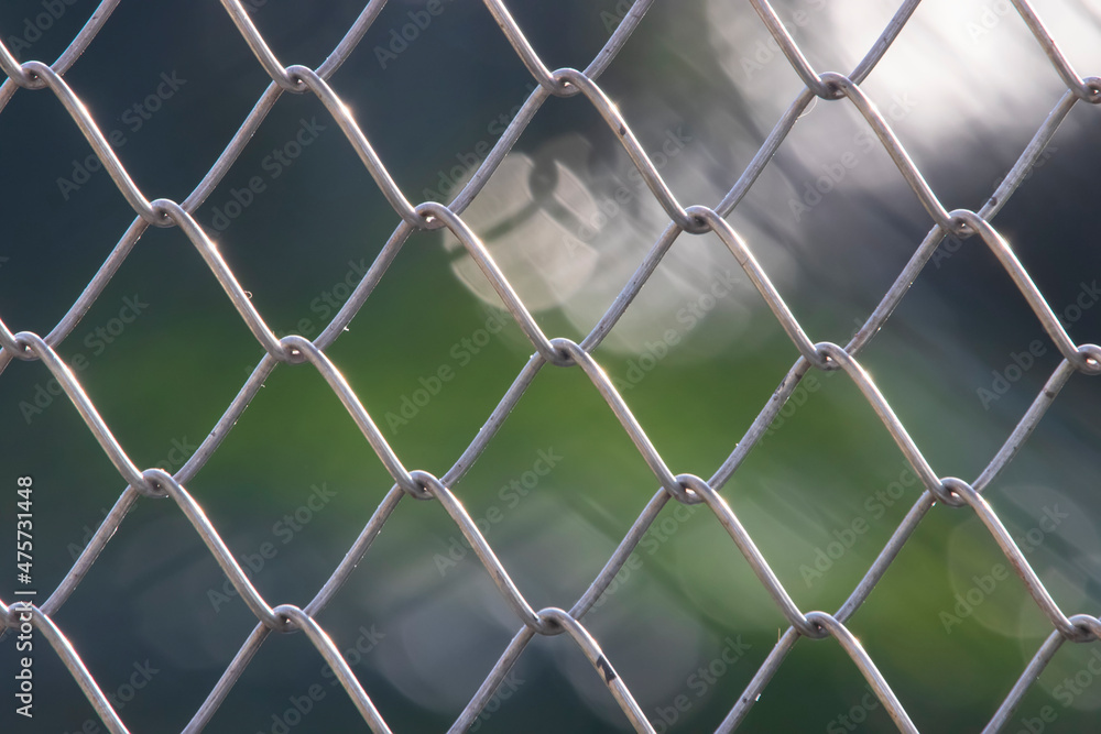 Design with chain link fence steel wire mesh on blurry background Design with chain link fence steel wire mesh on blurry background