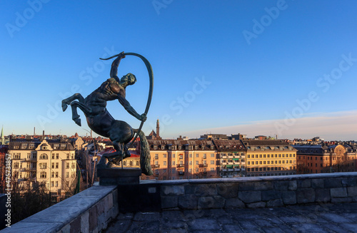 Photography Statue overlooking the sunny Stockholm skyline, Sweden.