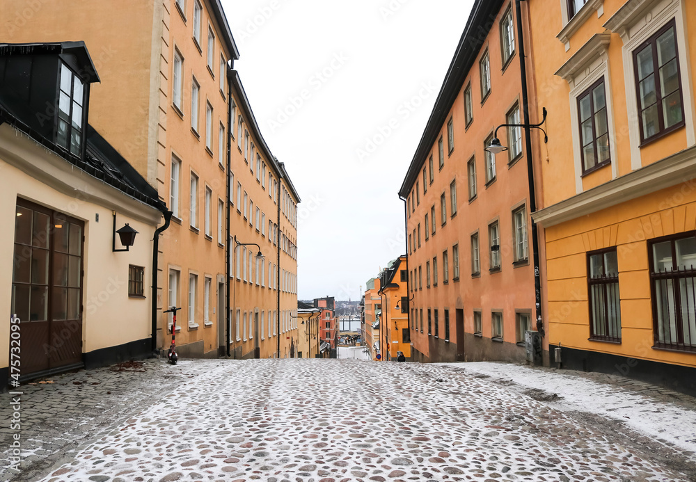 Traditional Swedish cobblestone street in Södermalm, Stockholm, Sweden, on a snowy winters day.